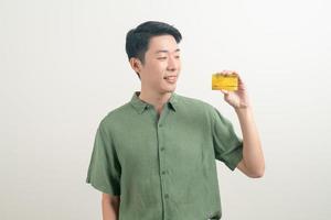 young Asian man holding credit card photo