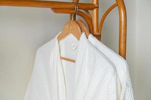 white bathrobe hanging in bathroom photo