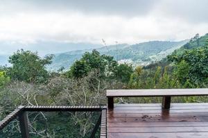 wood bar and chair with mountain hill background photo