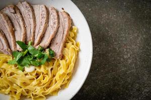 dried duck noodles in white bowl photo