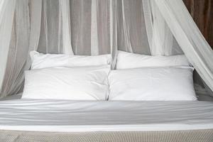 white comfortable pillows on bed photo