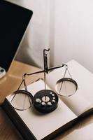 Justice and law concept.Male judge in a courtroom with the gavel, working with, computer and docking keyboard, eyeglasses, on table in morning light photo