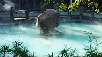 The hot spring view with the steam rising up from the hot water surface photo