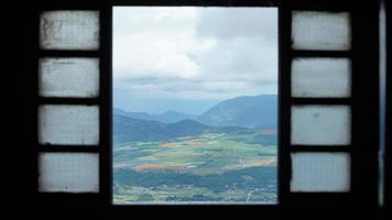 The beautiful mountains and yellow harvesting rice field view looking out of the window photo