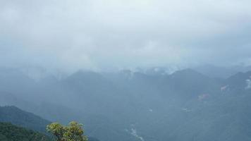 The raining mountains view with the foggy and misty raining droplets photo