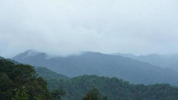 The raining mountains view with the foggy and misty raining droplets photo