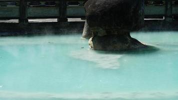 The hot spring view with the steam rising up from the hot water surface photo