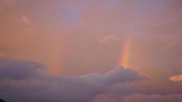 The colorful rainbow rising up in the sky after the summer rainning photo