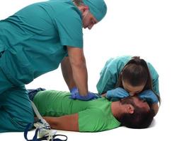 Female doctor with medical team giving cpr to patient. photo