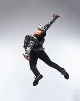 Cool young break dancer performing in studio on white background. photo