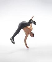 Cool young break dancer performing in studio on white background. photo