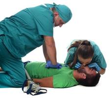 Female doctor with medical team giving cpr to patient. photo