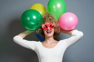 funny blonde women holding balloons celebrating new year photo