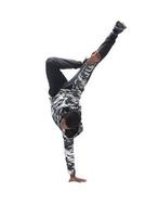 Cool young break dancer performing in studio on white background. photo