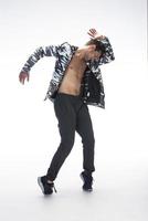 Cool young break dancer performing in studio on white background. photo