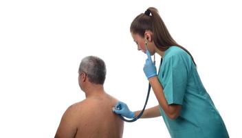 Female Doctor checking on patient with stethoscope. photo