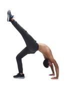 Cool young break dancer performing in studio on white background. photo