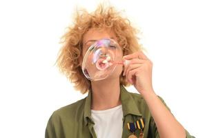 f young female model blowing soap bubbles photo