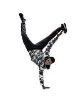 Cool young break dancer performing in studio on white background. photo