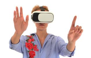 Pretty beautiful excited woman in VR headset looking up and trying to touch objects in virtual reality photo