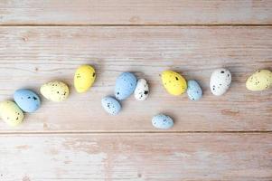 Top view on white,yellow and blue eggs. Easter flat lay photo