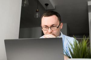 Closeup portrait of asian man thinking on problem solving looking at laptop screen, Descision making. Work from home photo