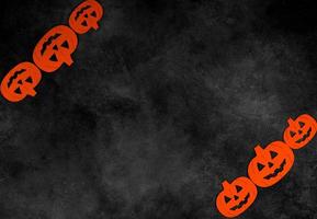 Top view on felted pumpkins on dark concrete background with place for text. Halloween concept photo