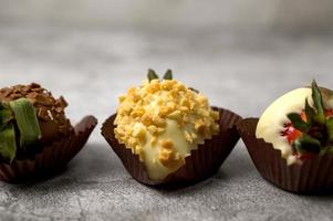 Closeup of chocolate strawberries covered in golden.Side view photo