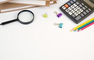 Back to school flatlay with books,calculator,pencils and other supplies on white bacground. Banner with place for text photo