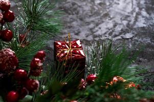 fir tree branches and gift boxes on dark background. Banner with place for text.Christmas background photo