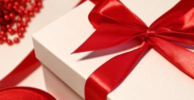 Closeup of a gift with big red bow.Christmas concept photo