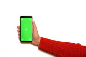 Hand in red clothes holding phone with chromascreen.Christmas mockup.Copyspace. Online shopping or christmas offers concept. photo