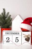Vertical christmas background with calendar,fir tree,santa hat,ornaments etc. December 25 photo