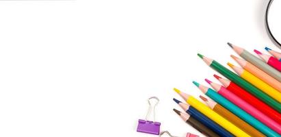 Back to school flat lay with colorful pencils,magnifier and paper clips. Banner with place for text photo