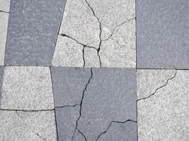 Cracks in pavement tiles. Masonry. The texture of the flooring. photo