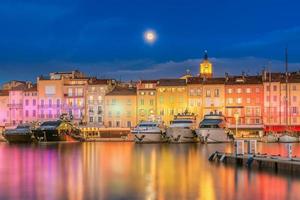 Scenic view of Christmas colorful illuminated Saint-Tropez against full moon photo
