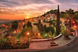 Scenic view of sunset over illuminated village of Bormes les Mimosas in Cote d'Azur south of France photo