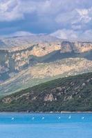 Scenic view of the french Alps with Sainte Croix lake in foreground in bad weather photo