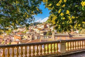 Scenic view of the small village of Bormes le Mimosas in south of France with yellow mimosas blooming under warm winter sunlight photo