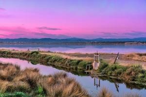 Scenic view of Les Salins dHyeres in Giens peninsula during purple colored blue hour sky in south of France photo