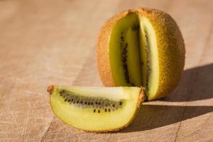 Close-up view of kiwi fruit cut open on wooden board in south of France photo