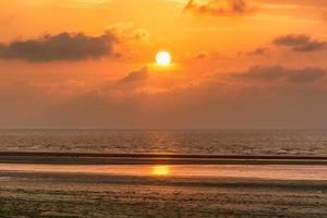 Scenic view of sunset over Deauville beach in Normandy, France against dramatic golden sky photo