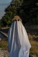 White ghost with black eyes, made from a bedsheet. whit hat photo