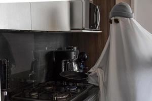 ghost cooking in a kitchen, modern kitchen, ghost white sheet, mexico latin america, mexico photo