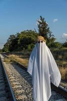 ghost on train tracks with train passing behind, at sunset, mexico latin america