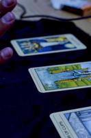 friends sharing tarot cards on a wooden table, guadalajara photo