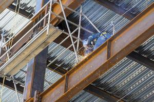 estructura de acero oxidada mientras un hombre está soldando juntas, méxico guadalajara foto