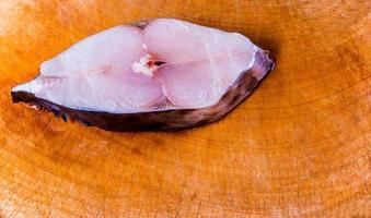 Pieces of mackerel on a wooden cutting board photo