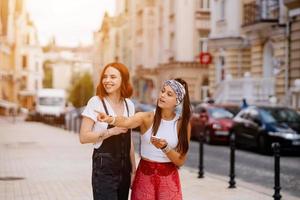 two young women walking outdoor having fun photo