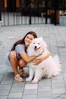 Woman hugs a big dog at sunset photo